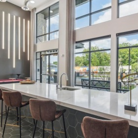 Enjoy our resident-only features a room with a table chairs and a large window