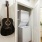 a room with a couple of guitars on the wall