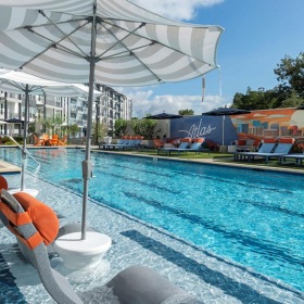 Shimmering resort-style pool a pool with chairs and umbrella